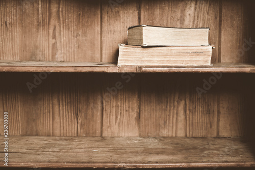 Old books on a wooden shelf