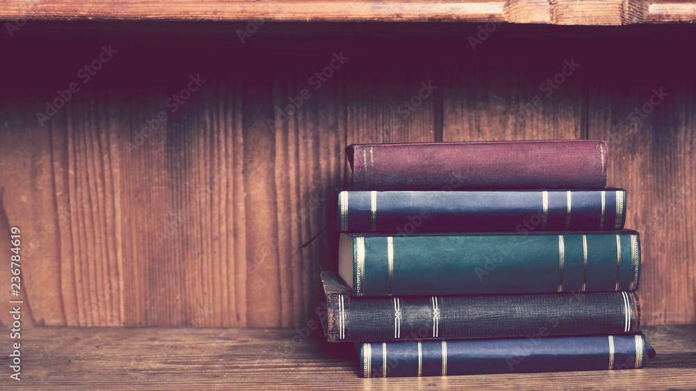 Pile of old books on a shelf Pile of old books on a shelf