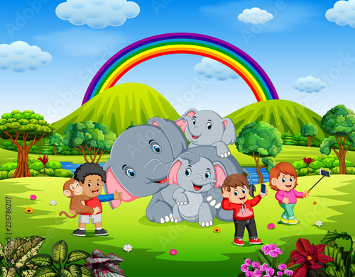 Kids having fun selfie photo with elephant in beautiful nature