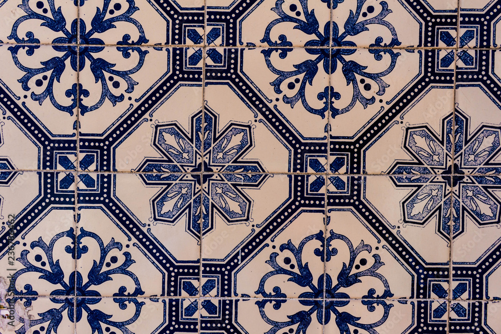Close view of several white and blue tiles with decorative guards.
