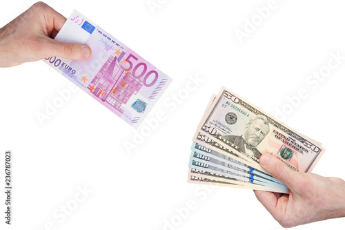 Hands with 500 euro and 50 100 dollars banknotes isolated on white background. Money exchange concept. Diagonal view.