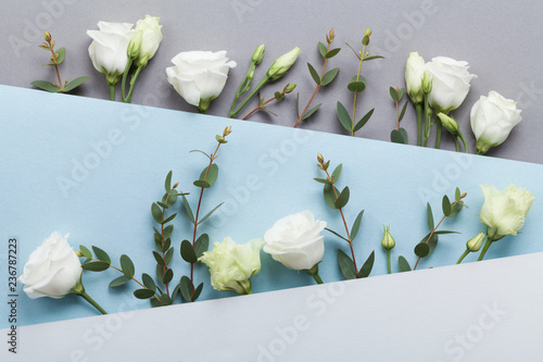 Empty notebook and gift or present box decorated white peony flowers on pastel table top view. Flat lay composition for birthday or wedding.