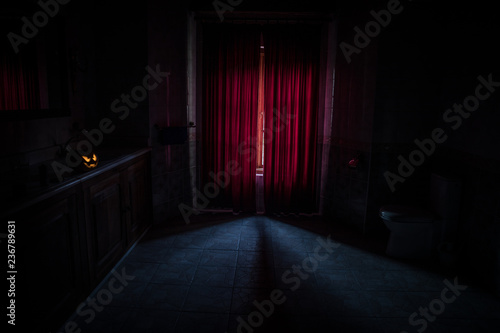 Backdrop of a brick fireplace wall in a vacant setting. Dark room with big windows and fireplace