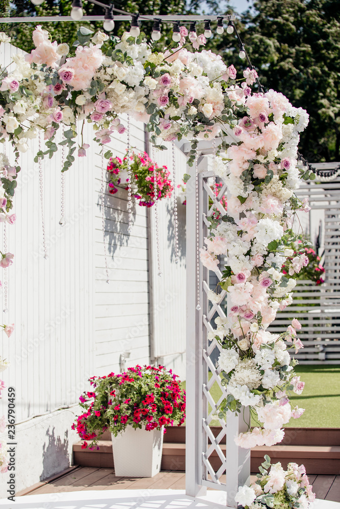White wooden arch in bloom, wedding arch White wooden arch in bloom, wedding arch