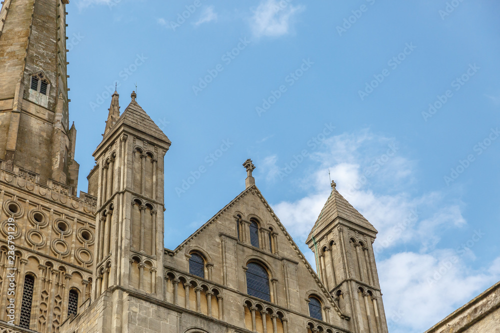 Part of the facade of the medieval style catholic cathedral of the city of Norwich, with the blue sky in the background, Norfolk