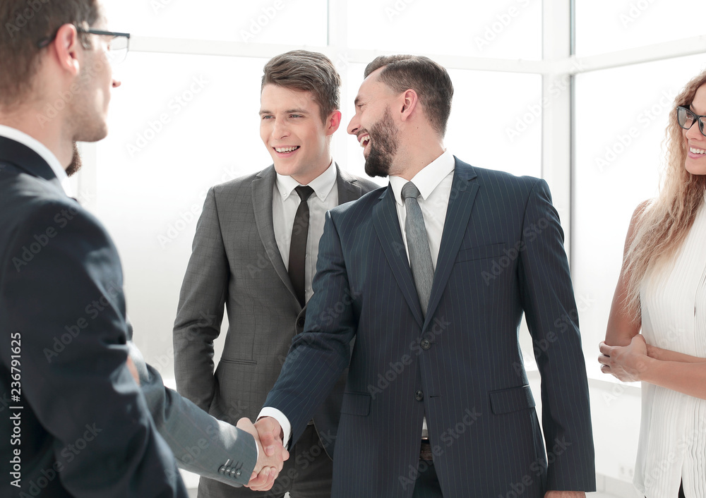 smiling businessman shaking hands with his partner smiling businessman shaking hands with his partner