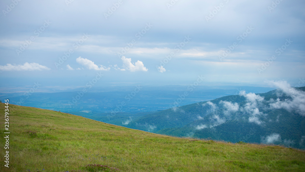 Mountain landscape with a view of a field far away