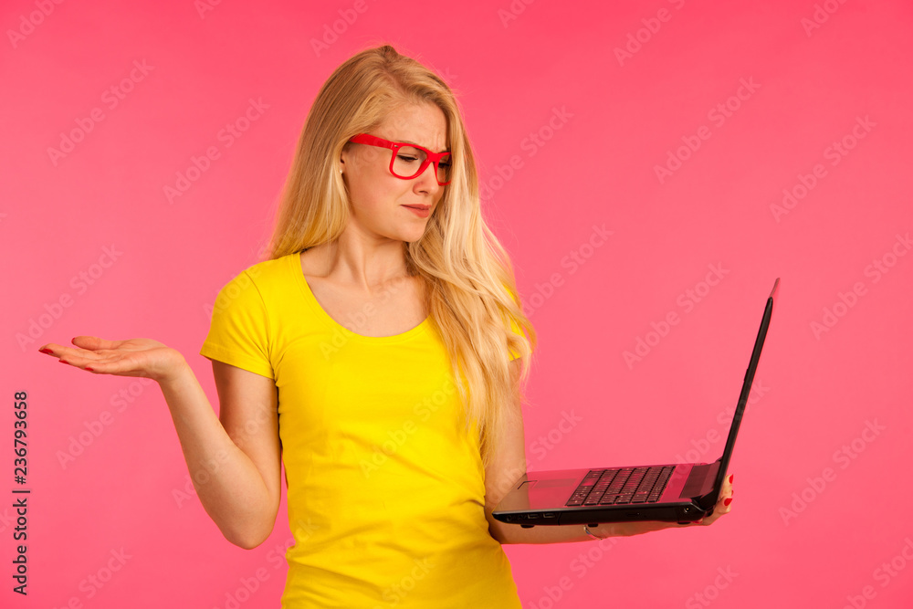 Beautiful young woman holds a laptop gesture surprise and success isoalted Beautiful young woman holds a laptop gesture surprise and success isoalted
