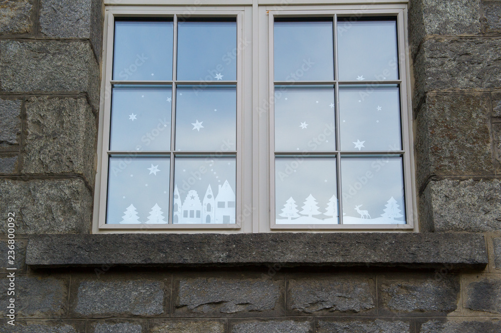 christmas decorations made of cut paper in a window christmas decorations made of cut paper in a window