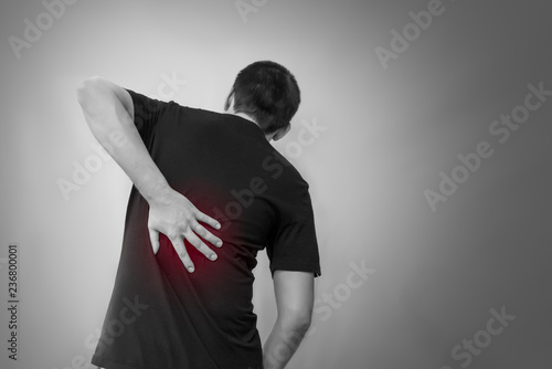 Man man touching his back for back pain, spine disease photo