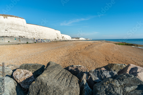 Saltdean beach seafront undercliff walkway with local people sunbathe on the beach at East Sussex Brighton marina, UK. photo
