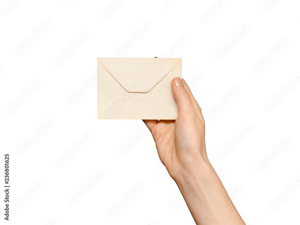 Female hand holding a vintage envelope,  isolated on white