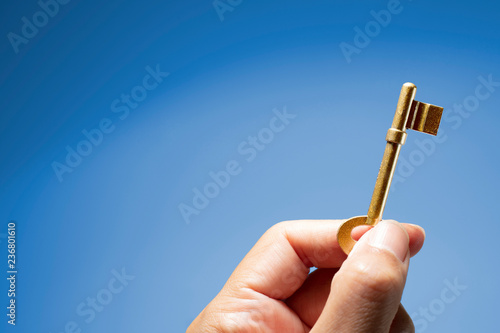 Hand holding the key to success photo