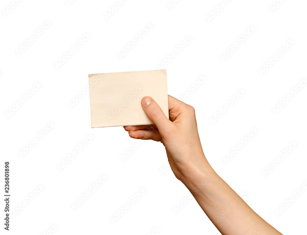 Fototapeta premium Female hand holding blank piece of card, isolated on white