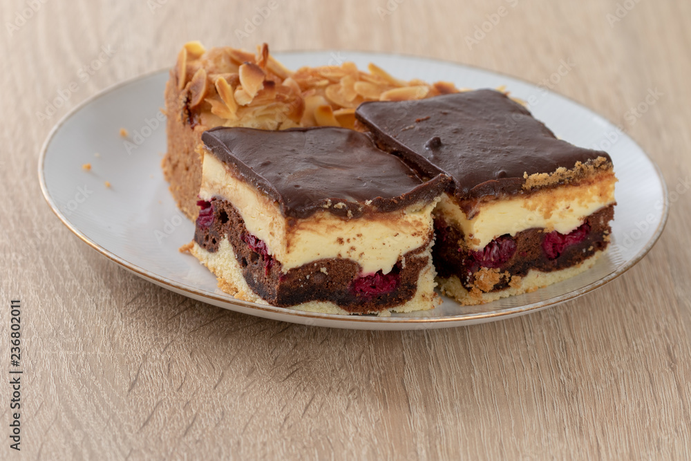 Some pieces of cake on white plate on wooden table Some pieces of cake on white plate on wooden table