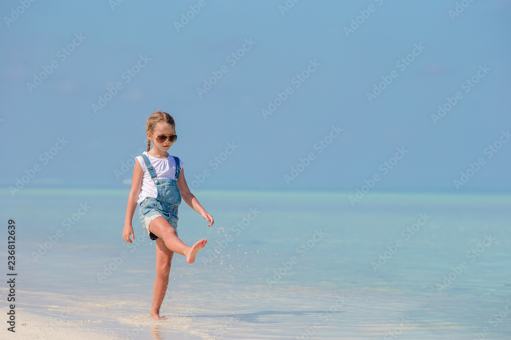 Adorable little girl at beach during summer vacation Adorable little girl at beach during summer vacation