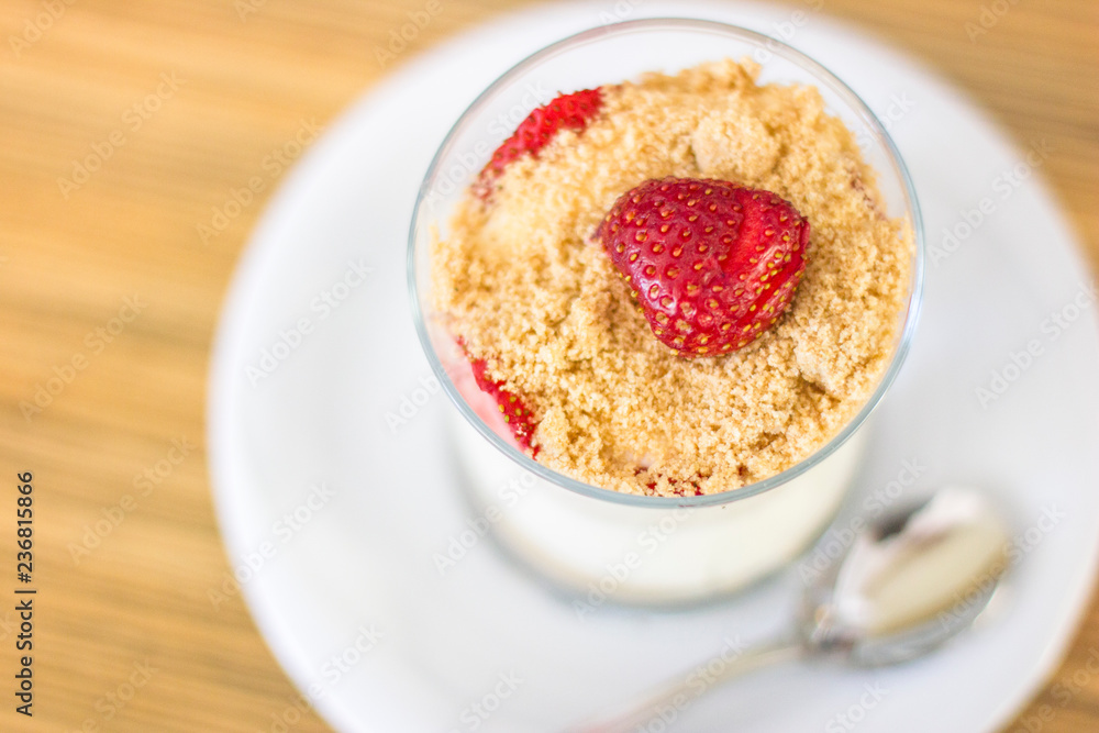 Magnolia dessert in a glass with cream and strawberries Magnolia dessert in a glass with cream and strawberries