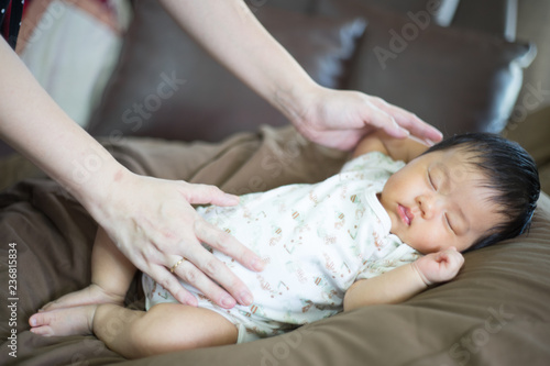 Infant sleep on gentle bed and look like she have a sweet dream