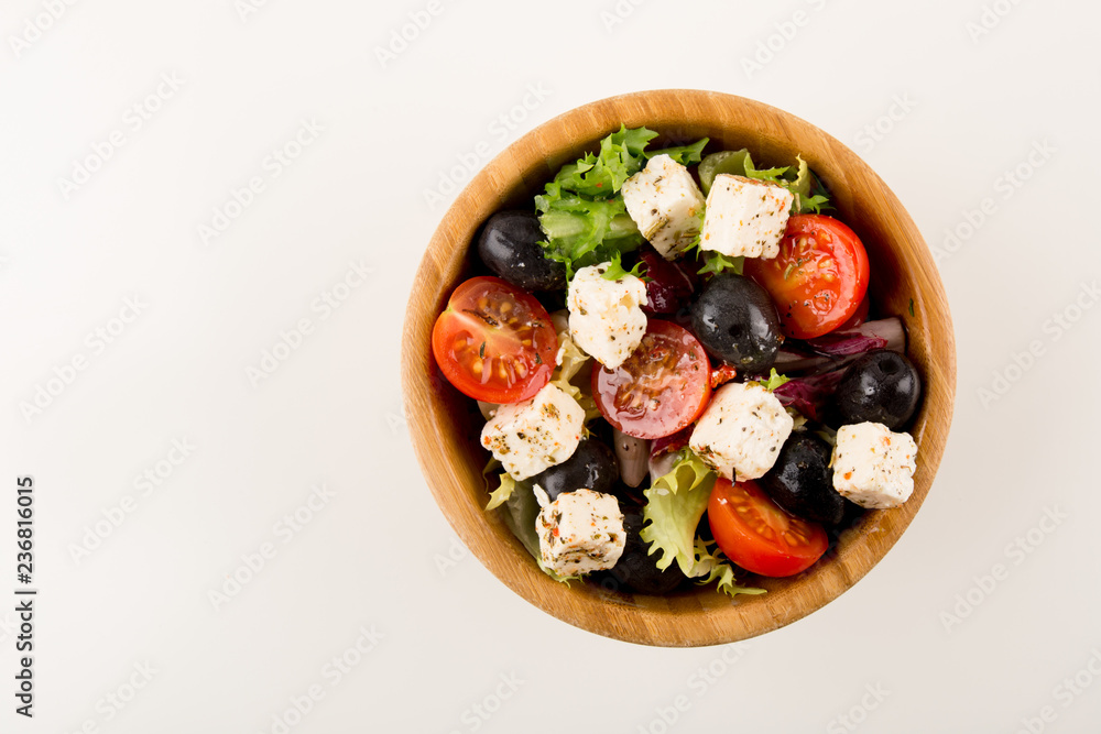 Gourmet Salad, in wooden bowl isolated on white background, copy space