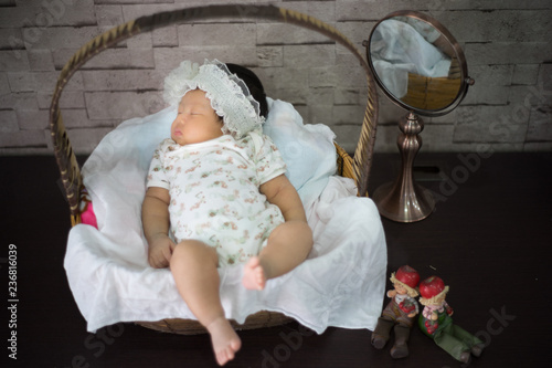 Infant sleep on gentle bed and look like she have a sweet dream