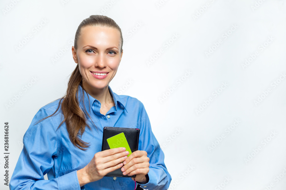Beautiful business woman is smiling and holding a card in her hand. Beautiful business woman is smiling and holding a card in her hand.