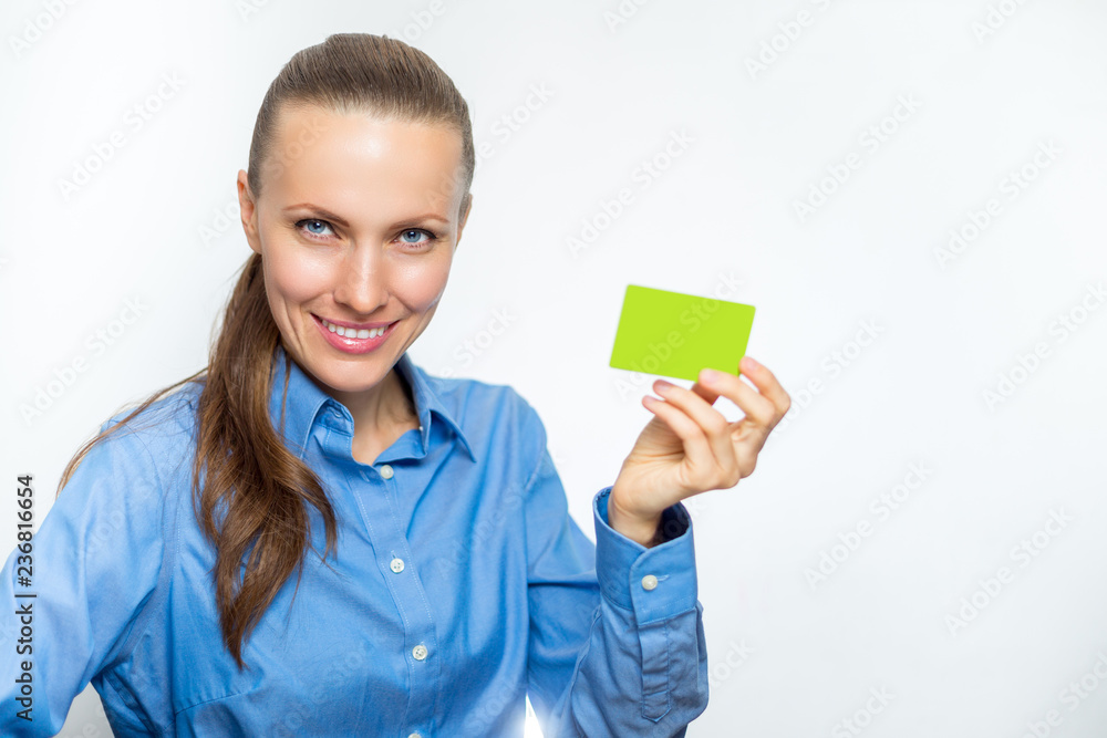 Beautiful business woman is smiling and holding a card in her hand. Beautiful business woman is smiling and holding a card in her hand.
