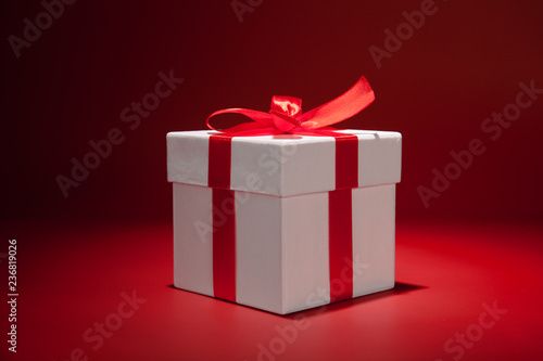 White gift box on red background. Copy spase