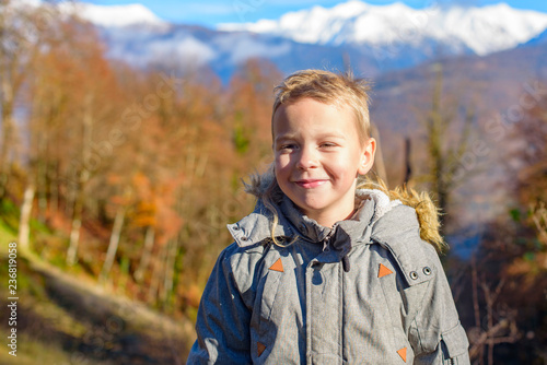 portrait of a little boy in the mountains
