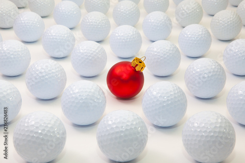 Pattern with white golf balls and red Christmas decoration