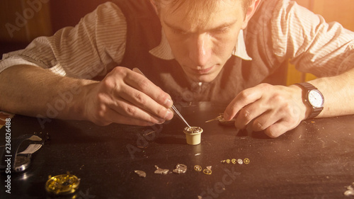 Photos The watchmaker is repairing the mechanical watches in his workshop
