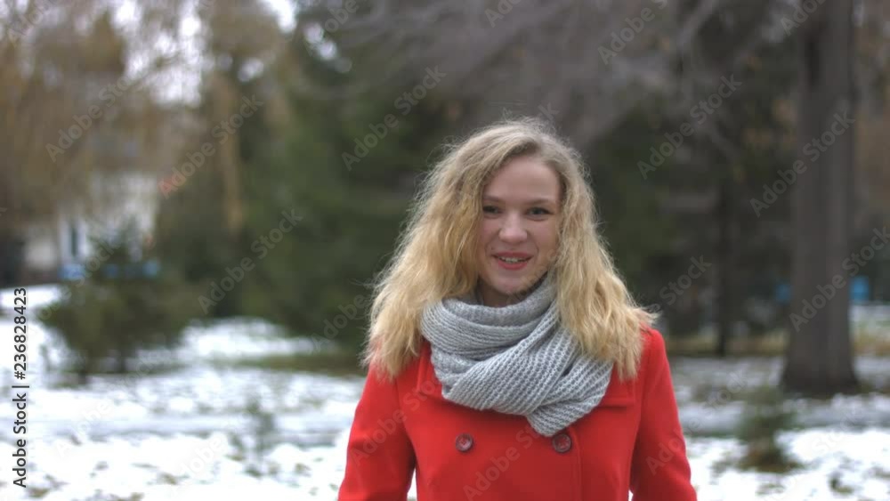 Girl in snowy park.
Girl dressed in red gently looks at the camera and then smiles. On the background are trees. Snowy weather. Girl in snowy park.
Girl dressed in red gently looks at the camera and then smiles. On the background are trees. Snowy weather.