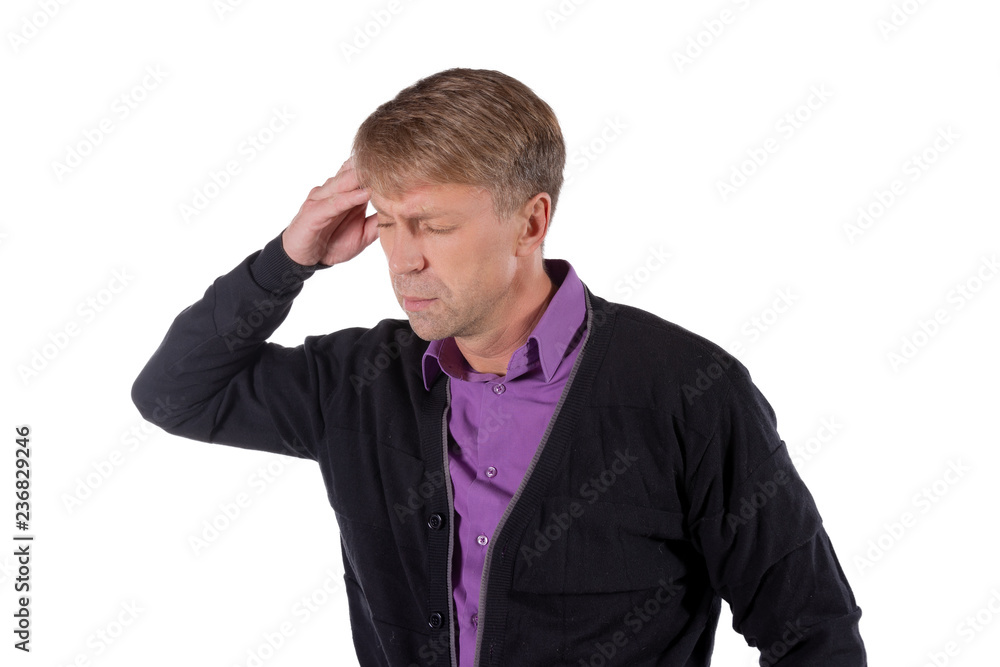 A handsome man holds his hands on his head on white background. Headache or migraine. A handsome man holds his hands on his head on white background. Headache or migraine.