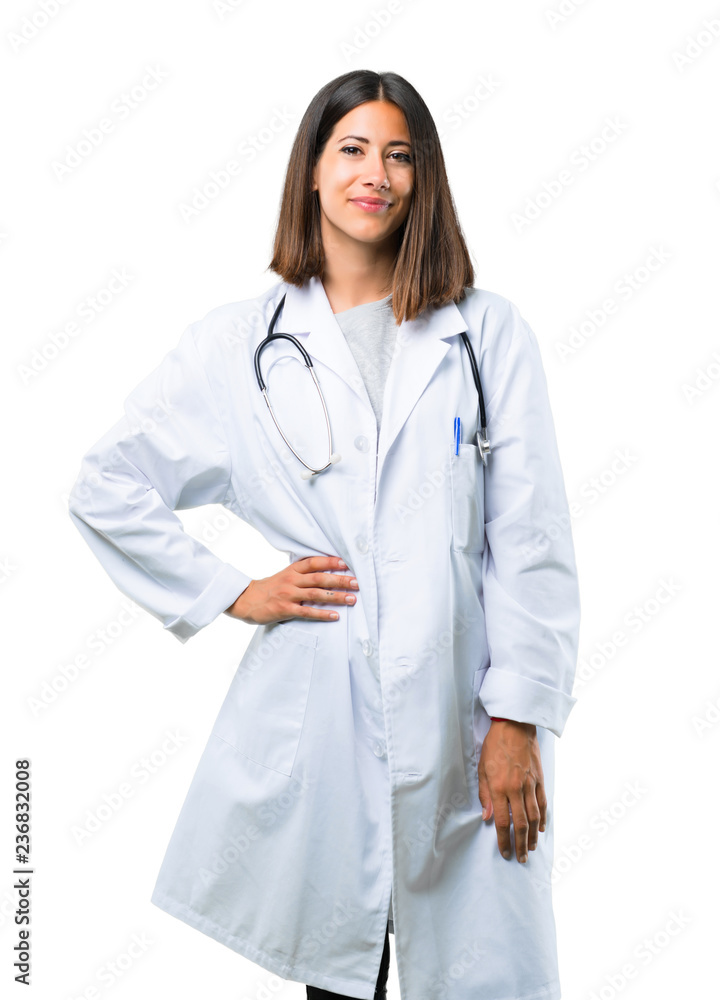 Doctor woman with stethoscope posing with arms at hip and smiling on isolated white background Doctor woman with stethoscope posing with arms at hip and smiling on isolated white background