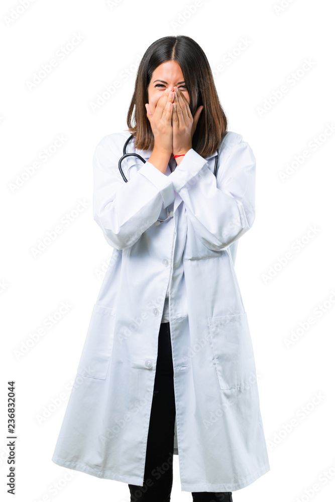 Doctor woman with stethoscope smiling a lot while covering mouth on isolated white background Doctor woman with stethoscope smiling a lot while covering mouth on isolated white background