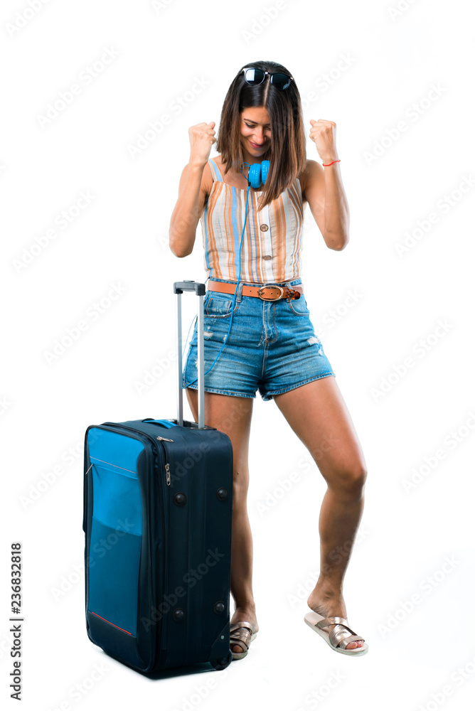 Full body of Girl traveling with her suitcase celebrating a victory and happy for having won a prize on isolated white background Full body of Girl traveling with her suitcase celebrating a victory and happy for having won a prize on isolated white background
