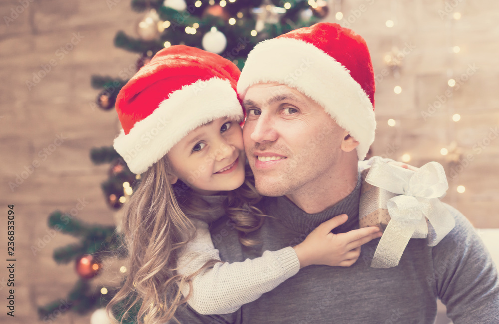 Dad and daughter, Christmas hat, tree, gift box Dad and daughter, Christmas hat, tree, gift box