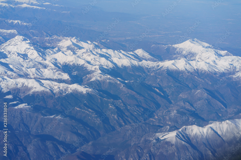 Fototapeta premium View of the Alps from the window of the plane