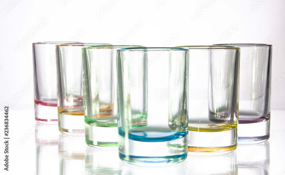 Six small colorful glasses on a white background Six small colorful glasses on a white background