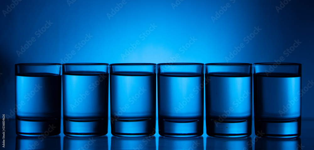 Six small multi-colored glasses on a bright background Six small multi-colored glasses on a bright background