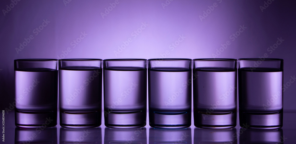 Six small multi-colored glasses on a bright background Six small multi-colored glasses on a bright background