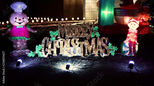 Merry Christmas decorative sign in front of house during winter.