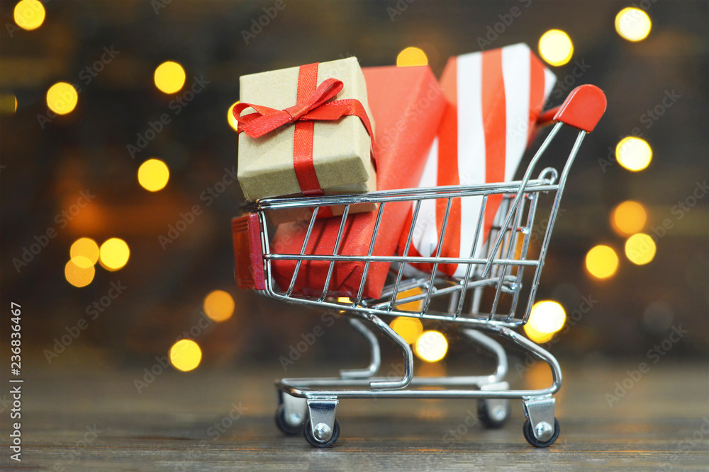 Christmas gifts shopping. Shopping cart with wrapped Christmas gifts Christmas gifts shopping. Shopping cart with wrapped Christmas gifts