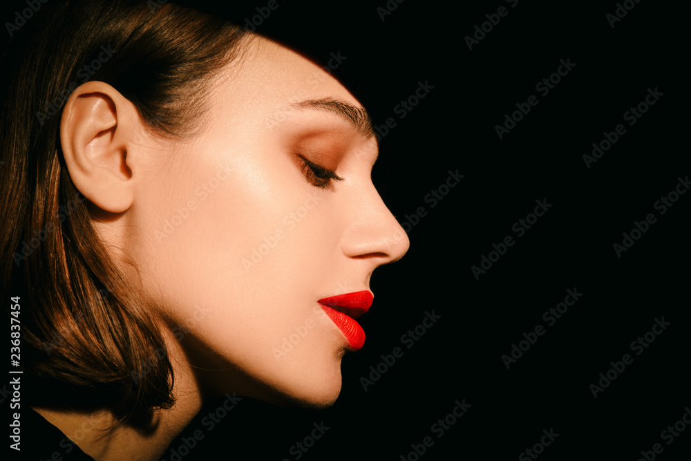 Beautiful brunette womam posing in costume and hat on black Beautiful brunette womam posing in costume and hat on black