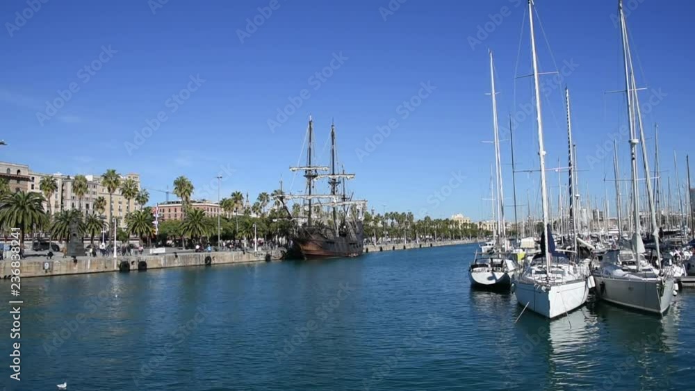 Old galleon and sailing boats on the port of Barcelona at sunny day Old galleon and sailing boats on the port of Barcelona at sunny day