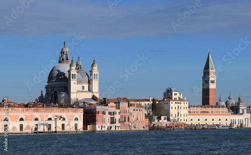 Venice, Italy. A view of the island of Dorsoduro taken from Giudecca Canal. The iconic Campanile di San Marco and the church of Santa Maria Della Salute.