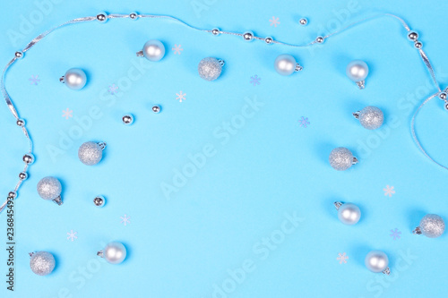 Many Christmas baubles on blue background.