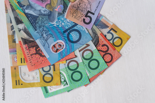 Obraz na plátně Colorful australian dollars laying on wooden table
