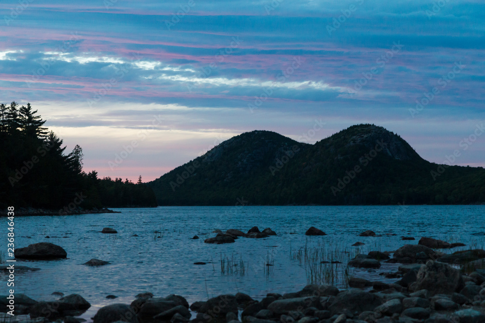 A landscape view of Jordan Pond during sunset in Acadia National Park in Maine.