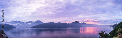 Panorama lilac sunset over Lucerne. Central Switzerland.