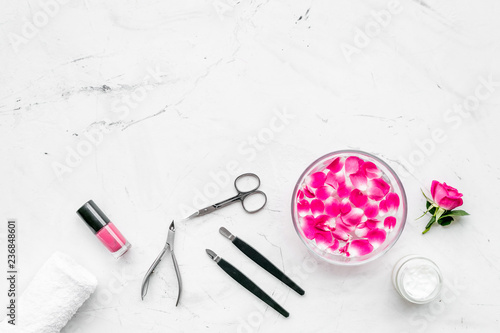 manicure and pedicure equipment for nail bar set on white stone background top view mockup